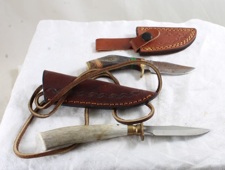 2 Fixed Blade Knives with Sheaths: 2 Fixed Blade Knives with Sheaths - Stag Handles. Damascus Steel and No Marking. Lot Size 9" x 3" x 3". 1 Lb. All information and photos, which are part of the description, are intended to be as accur