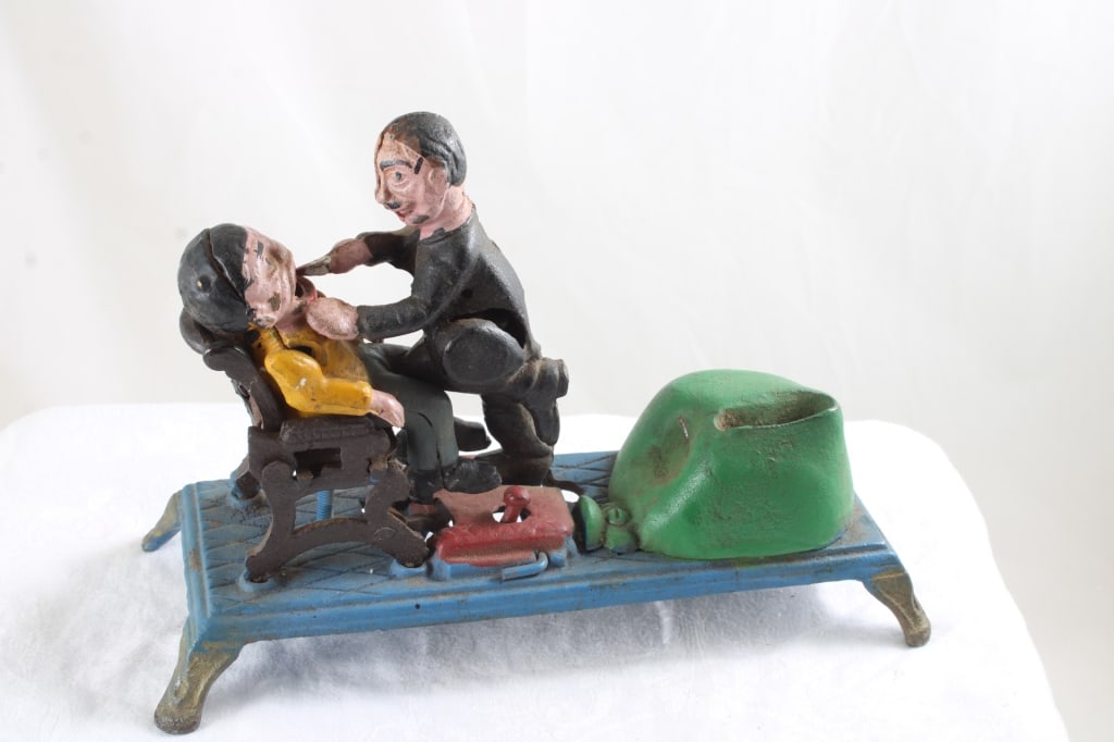 Reproduction Cast Iron Mechanical Dentist Bank: Reproduction Cast Iron Mechanical Dentist Bank - Lot Size 10" x 6" x 6". 7 Lbs. All information and photos, which are part of the description, are intended to be as accurate as possible, but errors
