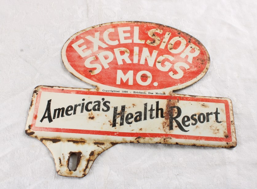 1986 Excelsior Springs MO. License Plate Topper: 1986 Excelsior Springs MO. License Plate Topper - Lot Size 6.5" x 5.5" x 1". 1 Lb. All information and photos, which are part of the description, are intended to be as accurate as possible, but