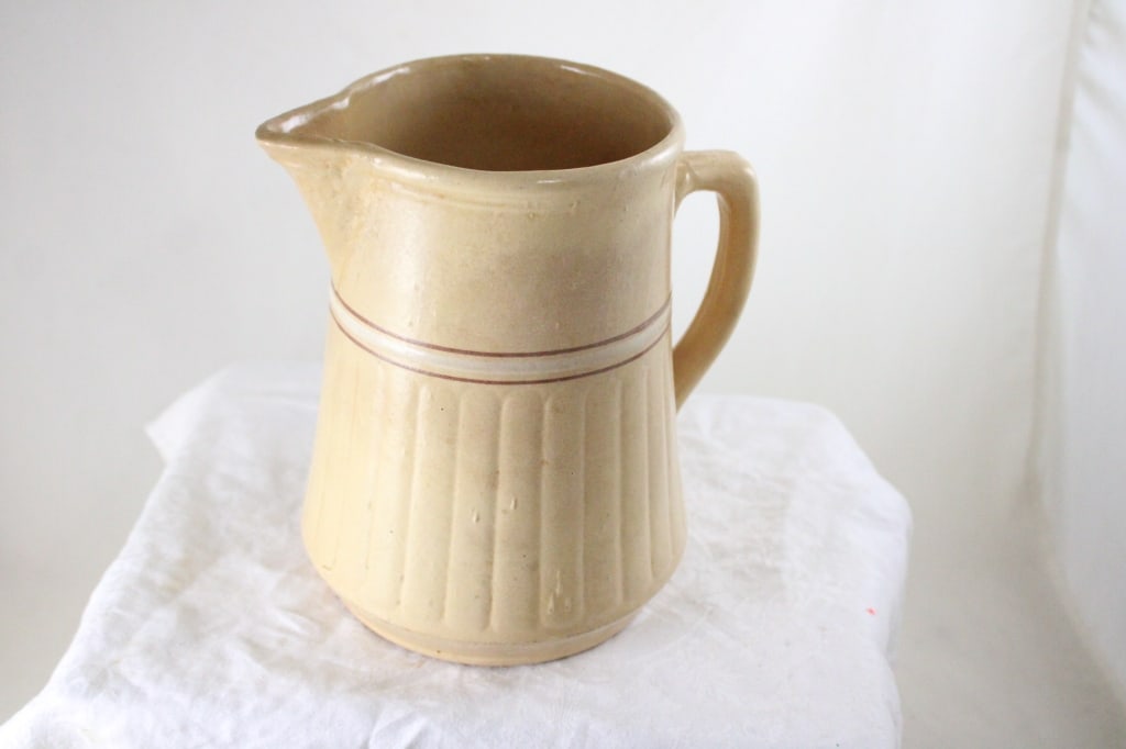 Red Wing Saffron Ware 8" Stoneware Pitcher: Red Wing Saffron Ware 8" Stoneware Pitcher - Chip on underside of spout. Lot Size 8" x 8" x 5". 3 Lbs. All information and photos, which are part of the description, are intended to be as accurate as