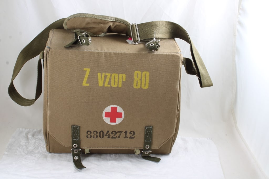 Czech Military 1st Aid Pack with Camping Gear: Czech Military 1st Aid Pack with Camping Gear - No 1st Aid items inside. Camping, Hiking, Biking Gear as pictured inside of this heavy duty military first aid pack. Lot Size 14" x 12" x 7". 10 Lbs.