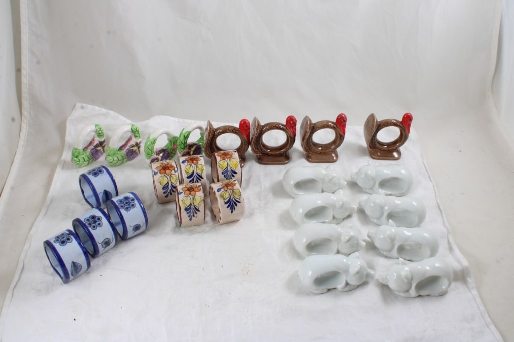 25 Porcelain Figural & Other Napkin Rings: 25 Porcelain Figural & Other Napkin Rings - Pigs, Turkeys & Other. Lot Size 12" x 9" x 3". 4 Lbs. All information and photos, which are part of the description, are intended to be as accurate as