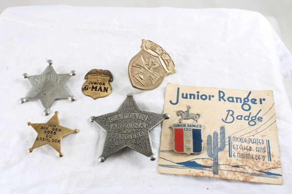 6 1950s Badges -Melvin Purvis Junior G-Man & More: 6 1950s Badges -Melvin Purvis Junior G-Man & More - Captain Arizona Rangers, Junior Ranger on Original Card, Sheriff, ICH BIN DER BOS, Maltese Cross Hat Badge. Lot Size 5" x 5" x 2". .5 Lb. All inform
