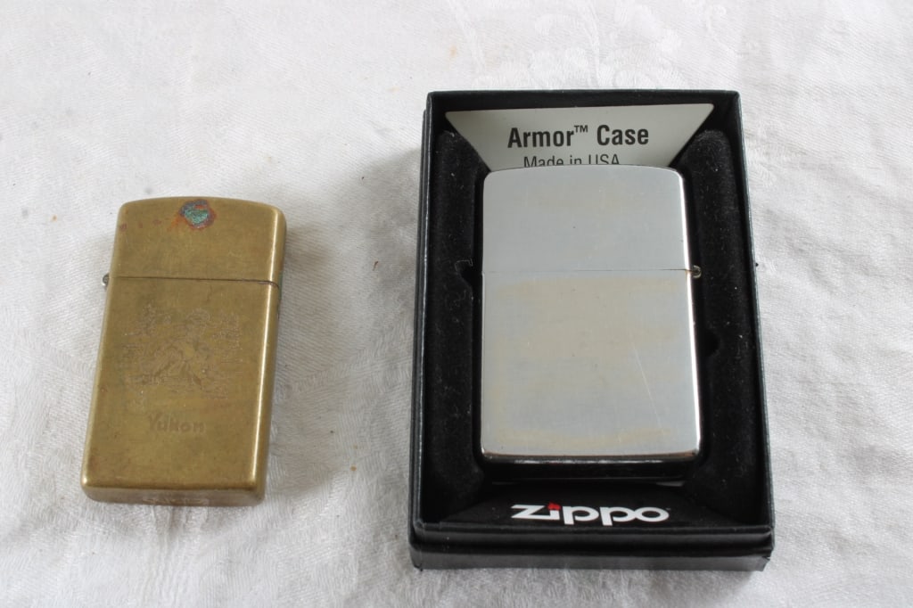 1981 Zippo w/Box & 1993 Zippo Brass Slim Lighters: 1981 Zippo w/Box & 1993 Zippo Brass Slim Lighters - Lot Size 4" x 3" x 2". .5 Lb. All information and photos, which are part of the description, are intended to be as accurate as possible, but errors