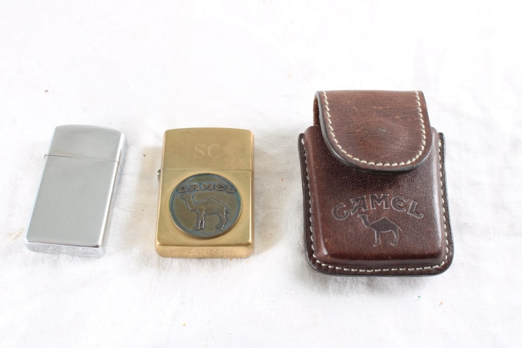 1932-1992 Brass Camel & Other Zippo Lighter & Case: 1932-1992 Brass Camel & Other Zippo Lighter & Case - 1967 Zippo Slim Lighter. Lot Size 4" x 3" x 3". .5 Lb. All information and photos, which are part of the description, are intended to be as accurat