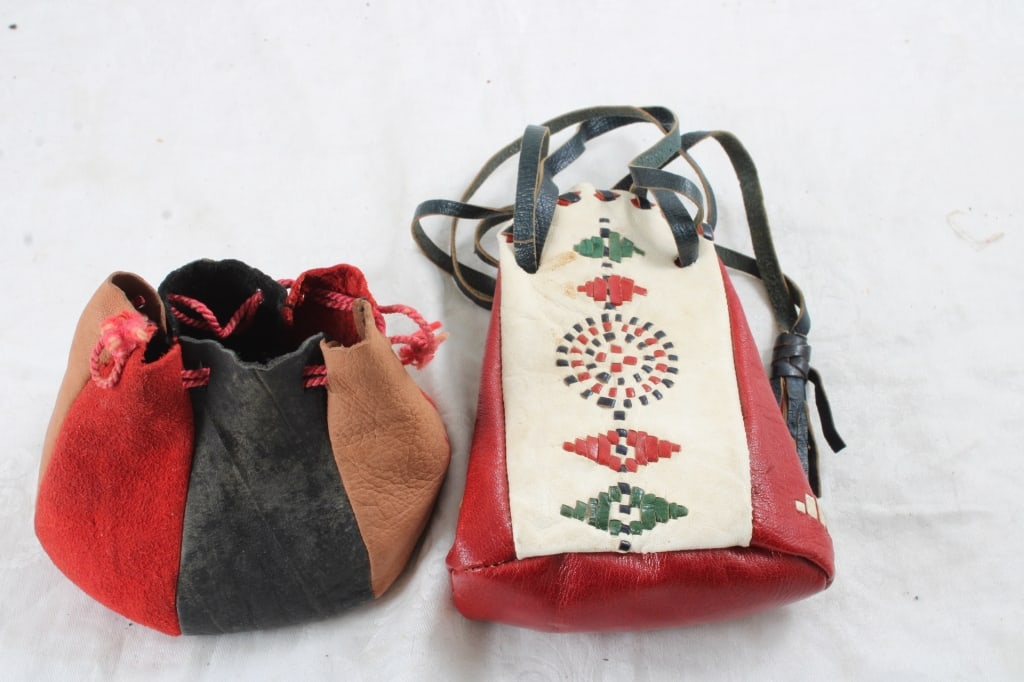 2 Leather Draw String Bags with Marbles & Jacks: 2 Leather Draw String Bags with Marbles & Jacks - One is Native American Design. Other is Suede. Lot Size 7" x 6" x 5". 2 Lbs. All information and photos, which are part of the description, are