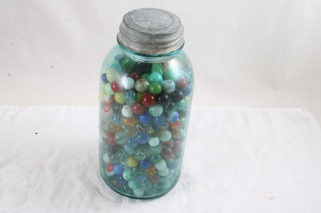 Half Gallon Ball Fruit Jar Full of Marbles: Half Gallon Ball Fruit Jar Full of Marbles - Lot Size 10" x 6" x 6". 7 Lbs. All information and photos, which are part of the description, are intended to be as accurate as possible, but errors are