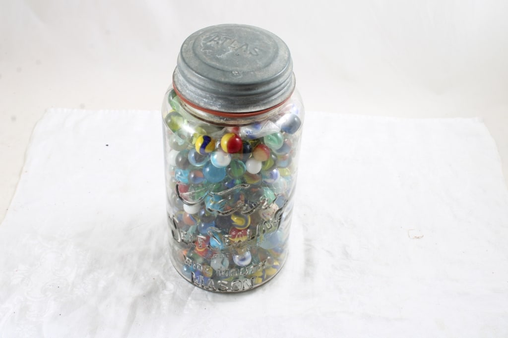 Half Gallon Ball Fruit Jar Full of Marbles: Half Gallon Ball Fruit Jar Full of Marbles - Lot Size 10" x 6" x 6". 7 Lbs. All information and photos, which are part of the description, are intended to be as accurate as possible, but errors are