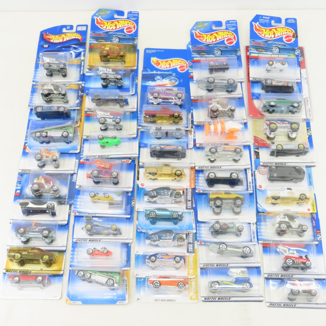 50 1990s & 2000s Hot Wheels Diecast Cars on cards: 50 1990s & 2000s Hot Wheels Diecast Cars on cards - Some Cards will likely have minor damage/bends. LOT SIZE: 10x10x10" 8 LBS All information and photos, which are part of the description) are
