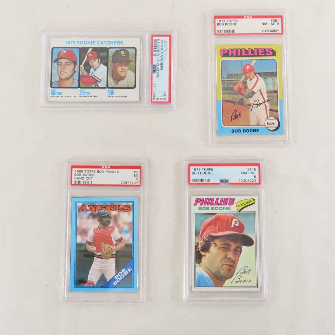 4 PSA Graded Bob Boone Cards 1973-1988: 4 PSA Graded Bob Boone Cards 1973-1988 - 1973 Topps Rookie Catchers #613 PSA 5 EX, 1975 Topps #351 PSA 8 NM-MT, 1977 Topps #545 PSA 8 NM-MT, 1988 Topps Box Panels #D PSA 5 EX. Lot Size 5.5x3.5x1" 1