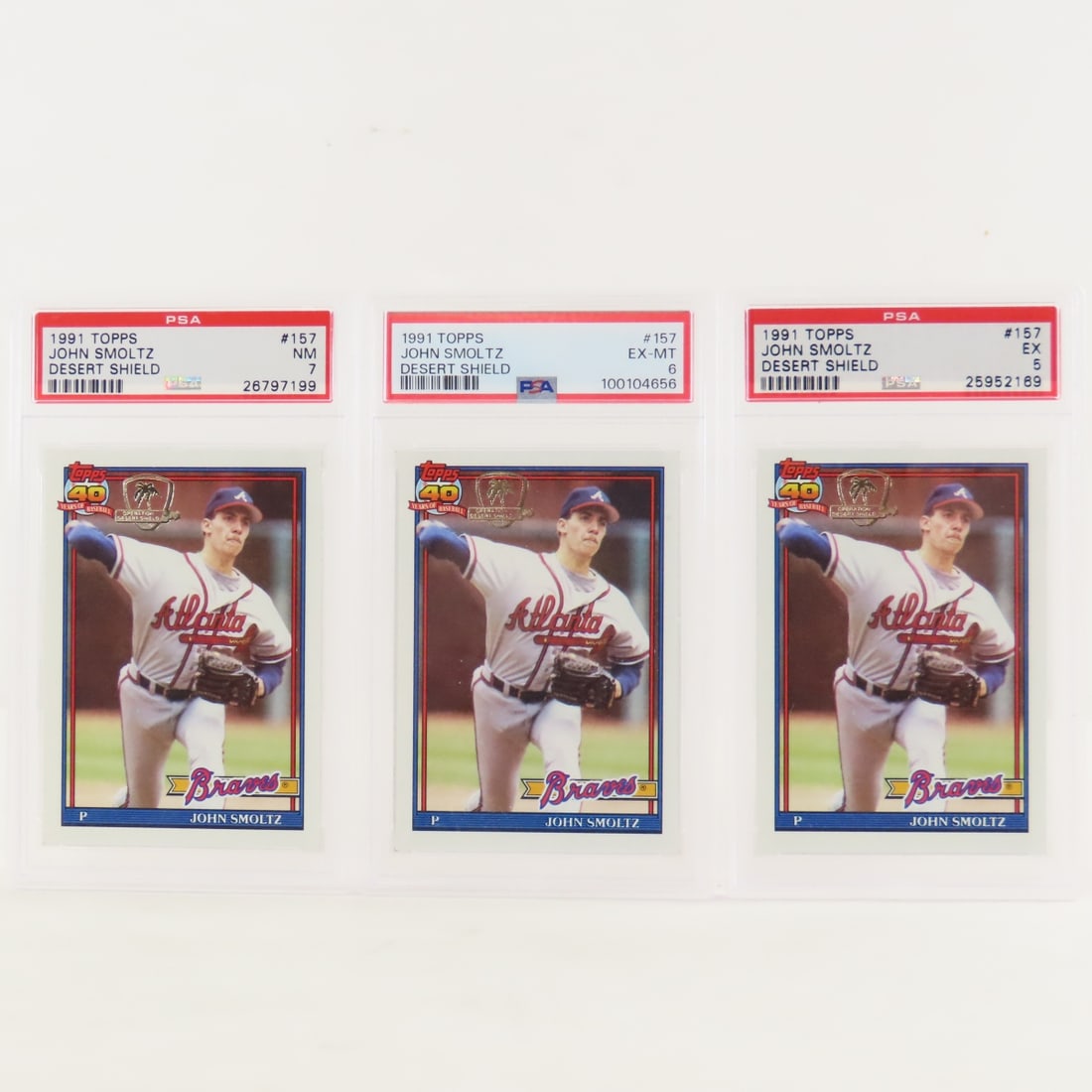3 1991 Topps Desert Shield John Smoltz #157 PSA: 3 1991 Topps Desert Shield John Smoltz #157 PSA - 1 PSA 7 NM, 1 PSA 6 EX-MT, & 1 PSA 5 EX. Lot Size 5.5x3.5x1" 1 LB All information and photos, which are part of the description, are intended to be