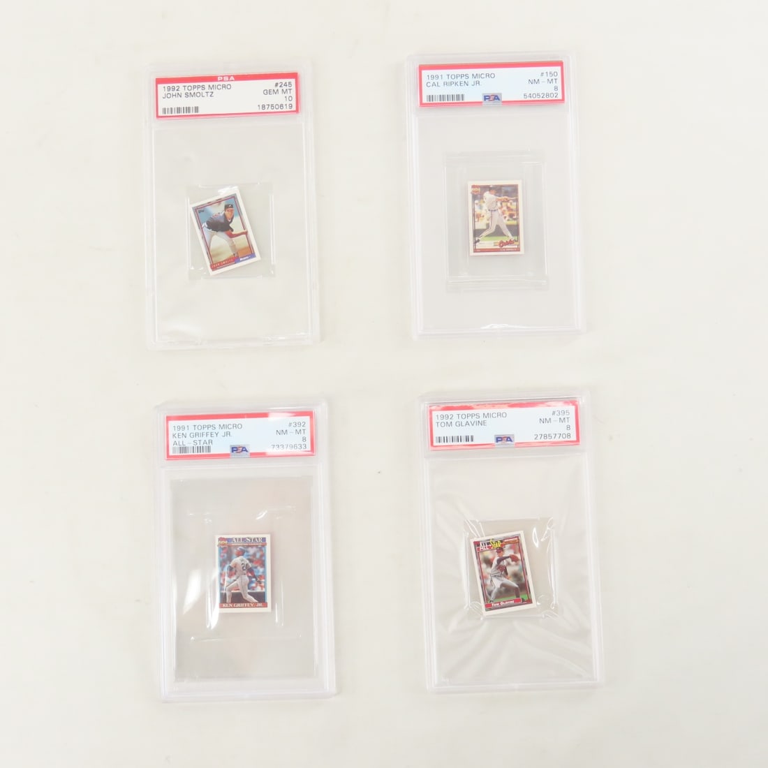 4 PSA Graded 1991 & 1992 Topps Micro Cards: 4 PSA Graded 1991 & 1992 Topps Micro Cards - 1991 Ken Griffey Jr. #392 PSA 8 NM-MT, 1991 Cal Ripken Jr. #150 PSA 8 NM-MT, 1992 John Smoltz #245 PSA 10 Gem MT, 1992 Tom Glavine #395 PSA 8 NM-MT. Lot