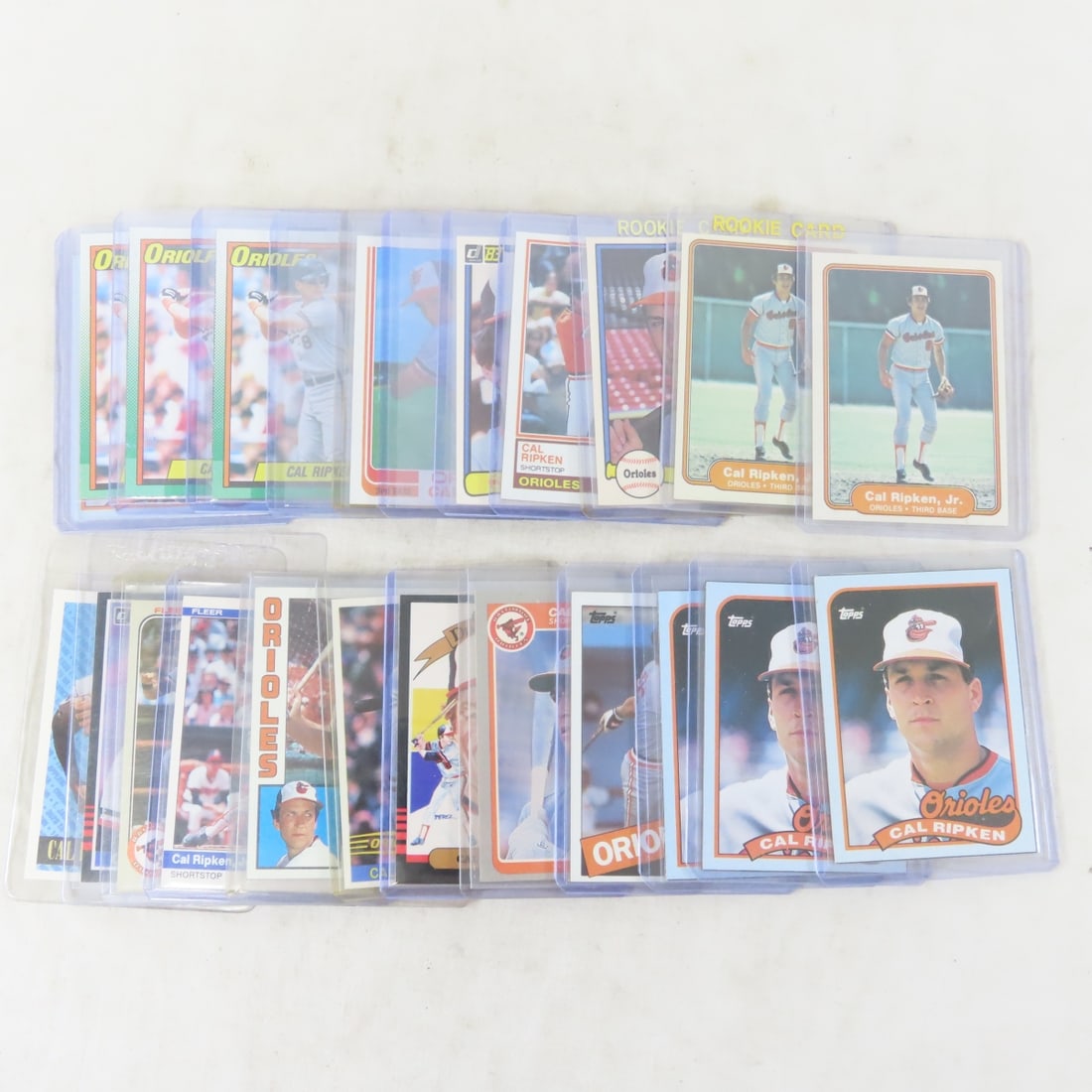 24 Cal Ripken Jr Baseball Cards including Rookies: 24 Cal Ripken Jr Baseball Cards including Rookies - LOT SIZE: 5x4x2" 1 LB All information and photos, which are part of the description, are intended to be as accurate as possible, but errors are