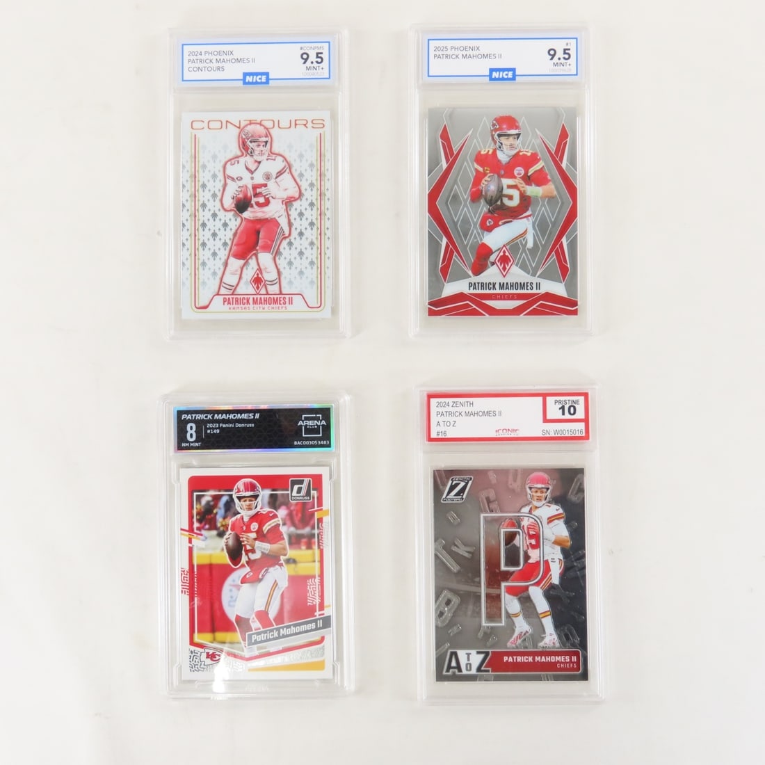 4 Graded Patrick Mahomes II Football Cards: 4 Graded Patrick Mahomes II Football Cards - 2024 Phoenix Contours #CONPMS NICE 9.5 Mint+, 2025 Phoenix #1 NICE 9.5 Mint+, 2024 Zenith Ato Z #6 ICONIC Pristine 10, 2023 Panini Donruss #149 ARENA CLUB 