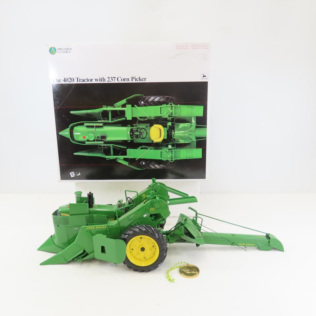 ERTL Precision 1:16 John Deere 4020 w/Corn Picker: ERTL Precision 1:16 John Deere 4020 w/Corn Picker - Diecast Metal. tractor w/237 Corn Picker. Precision Classics with Coin, booklet & box LOT SIZE: 16x13x8" 9 LBS All information and photos, which are