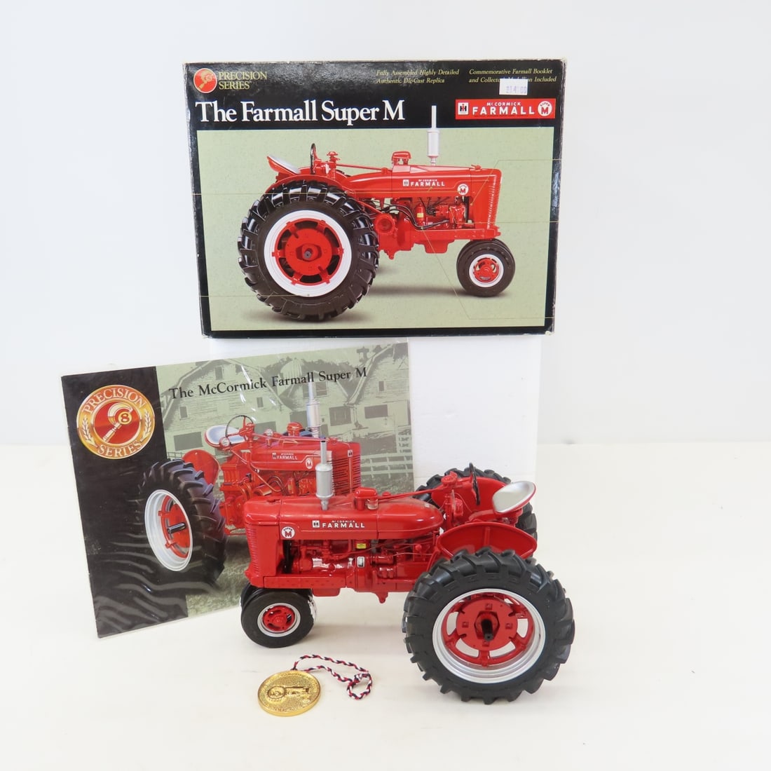 ERTL Precision 1:16 Farmall Super M Tractor: ERTL Precision 1:16 Farmall Super M Tractor - Diecast Metal. Precision Series with Coin & booklet in box. LOT SIZE: 10x8x8" 4 LBS All information and photos, which are part of the description, are