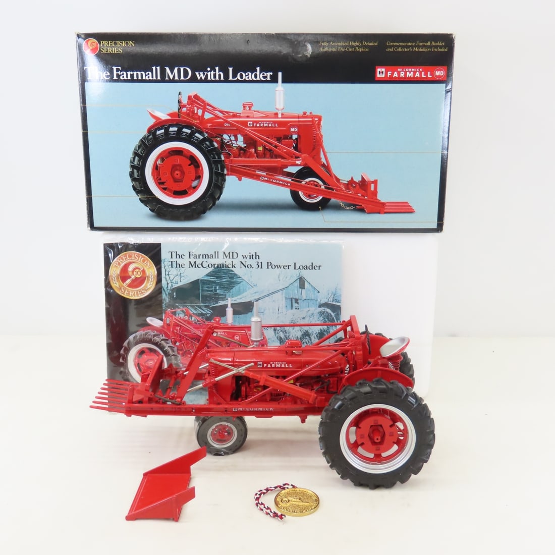 ERTL Precision 1:16 Farmall MD Tractor with Loader: ERTL Precision 1:16 Farmall MD Tractor with Loader - Diecast Metal. McCormick Farmall Precision Series with Coin & booklet in box. LOT SIZE: 16x13x8" 8 LBS All information and photos, which are part o