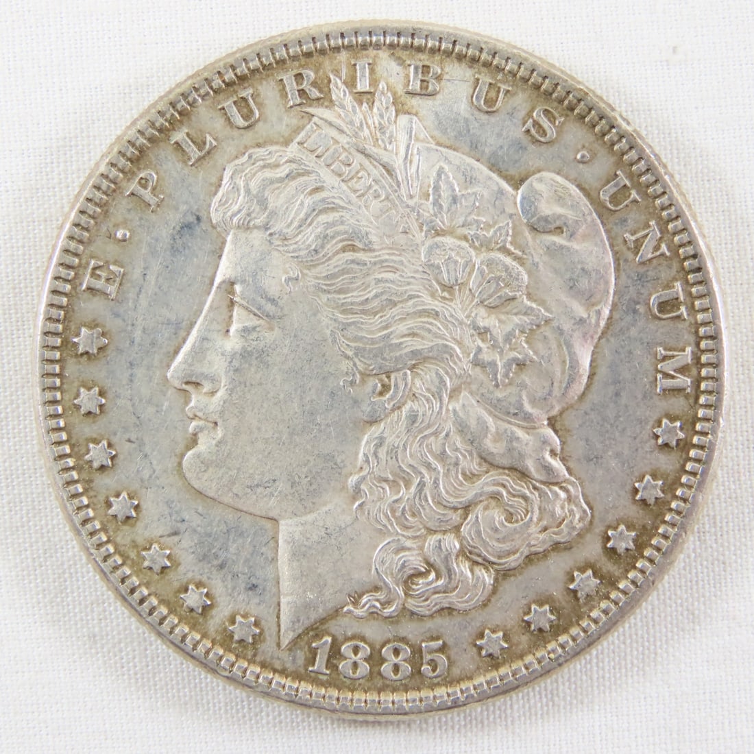 1885 Morgan Silver Dollar: 1885 Morgan Silver Dollar - LOT SIZE: 2x2x1" 1 LB All information and photos, which are part of the description, are intended to be as accurate as possible, but errors are possible. No item may be