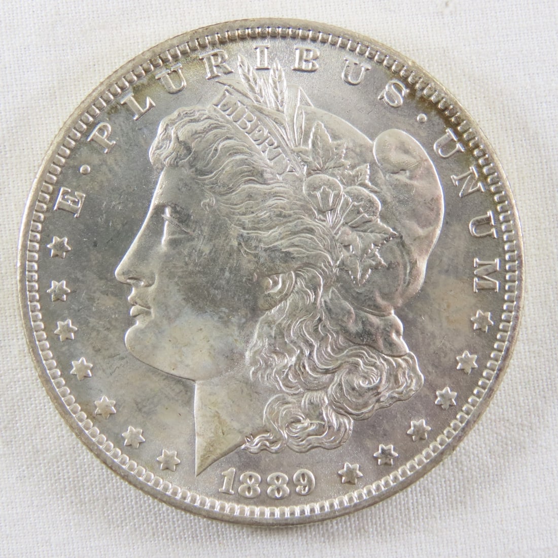 1889 O Morgan Silver Dollar: 1889 O Morgan Silver Dollar - LOT SIZE: 2x2x1" 1 LB All information and photos, which are part of the description, are intended to be as accurate as possible, but errors are possible. No item may be