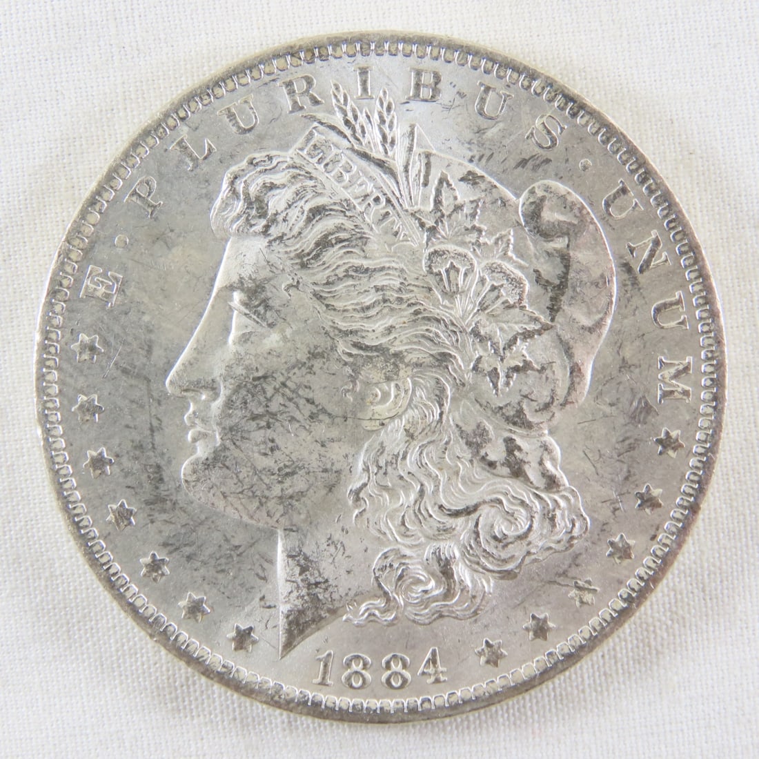 1884 O Morgan Silver Dollar: 1884 O Morgan Silver Dollar - LOT SIZE: 2x2x1" 1 LB All information and photos, which are part of the description, are intended to be as accurate as possible, but errors are possible. No item may be