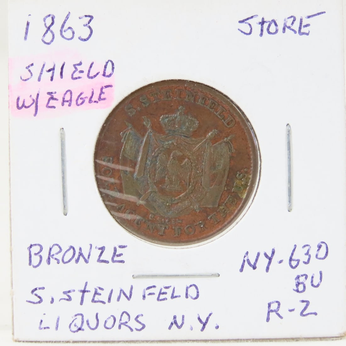 1863 Civil War Store Token Shield with Eagle: 1863 Civil War Store Token Shield with Eagle - S. Steinfeld, New York Principal Depot-French Cognac Ny-630Bu Au R-2 LOT SIZE: 2x2x1" 1 LB All information and photos, which are part of the