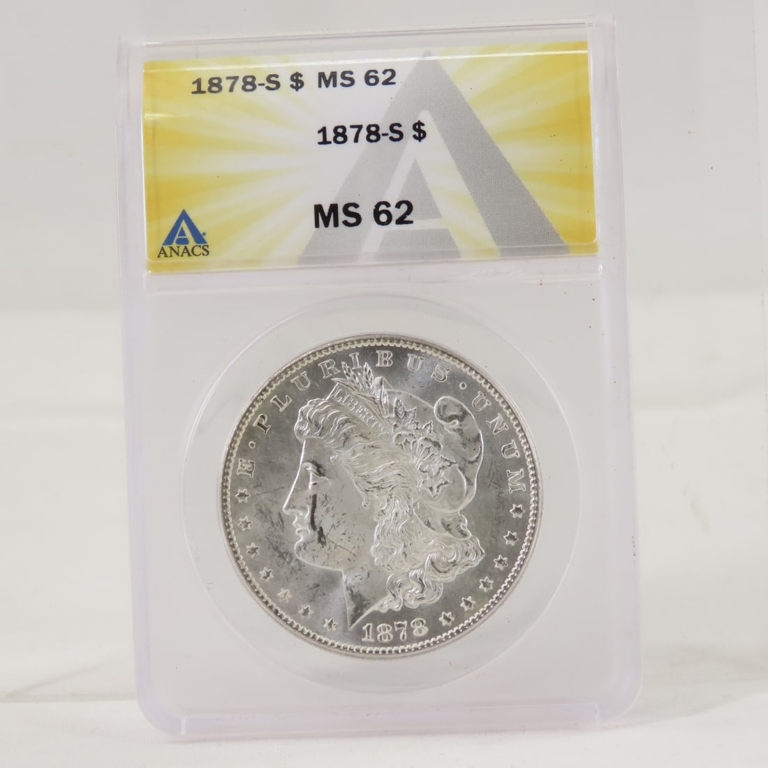 1878 S Morgan Silver Dollar ANACS MS62: 1878 S Morgan Silver Dollar ANACS MS62 - LOT SIZE: 4x3x1" 1 LB All information and photos, which are part of the description, are intended to be as accurate as possible, but errors are possible. No