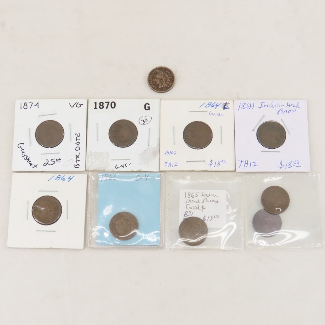 10 Indian Head Cents 1864-1874: 10 Indian Head Cents 1864-1874 - 1 1864 Copper Nickel, 3 1864 Bronze, 1865, 1866 x2, 1869, 1870, 1874 LOT SIZE: 2x2x2" 1 LB All information and photos, which are part of the description, are intended