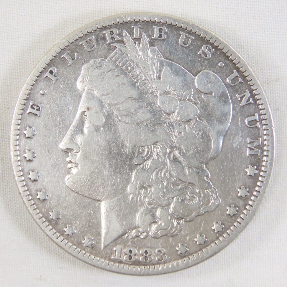 1883 Morgan Silver Dollar: 1883 Morgan Silver Dollar - LOT SIZE: 2x2x1" 1 LB All information and photos, which are part of the description, are intended to be as accurate as possible, but errors are possible. No item may be