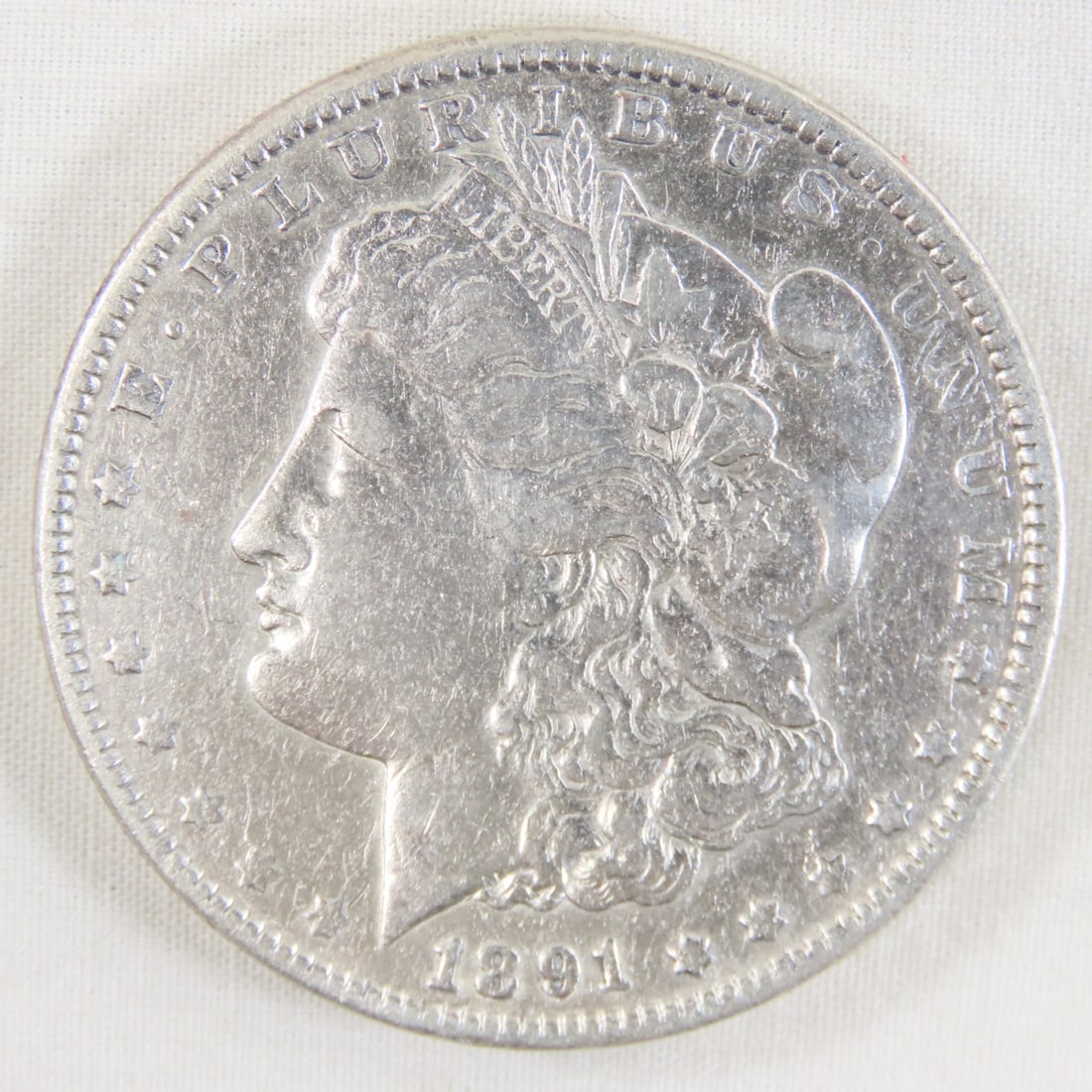 1891 Morgan Silver Dollar: 1891 Morgan Silver Dollar - LOT SIZE: 2x2x1" 1 LB All information and photos, which are part of the description, are intended to be as accurate as possible, but errors are possible. No item may be ret