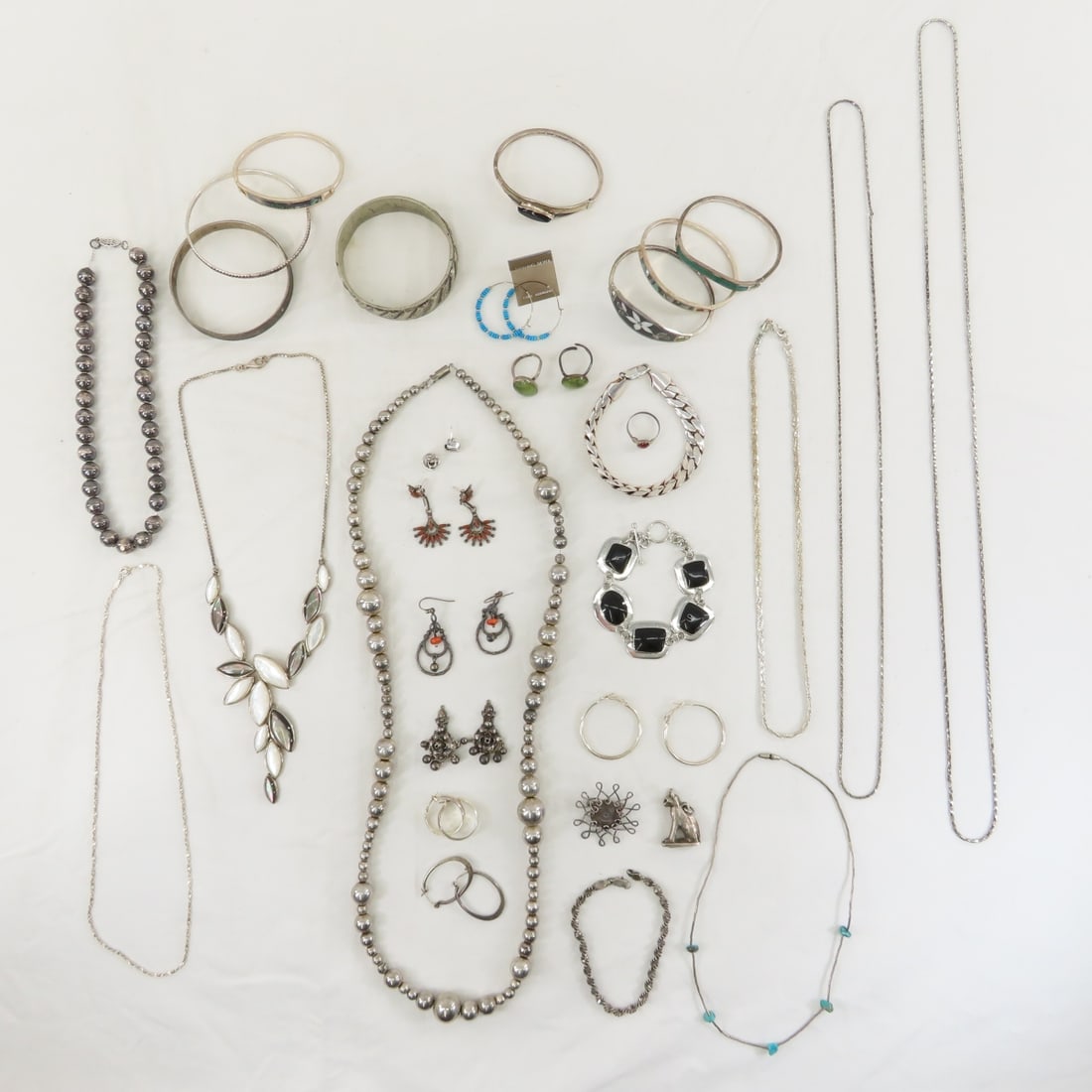 Mexican & Other Silver Jewelry, Some With Stones: Mexican & Other Silver Jewelry, Some With Stones - inlay bracelets, bead necklaces, and more. LOT SIZE: 8x8x8" 2 LBS All information and photos, which are part of the description, are intended to be a