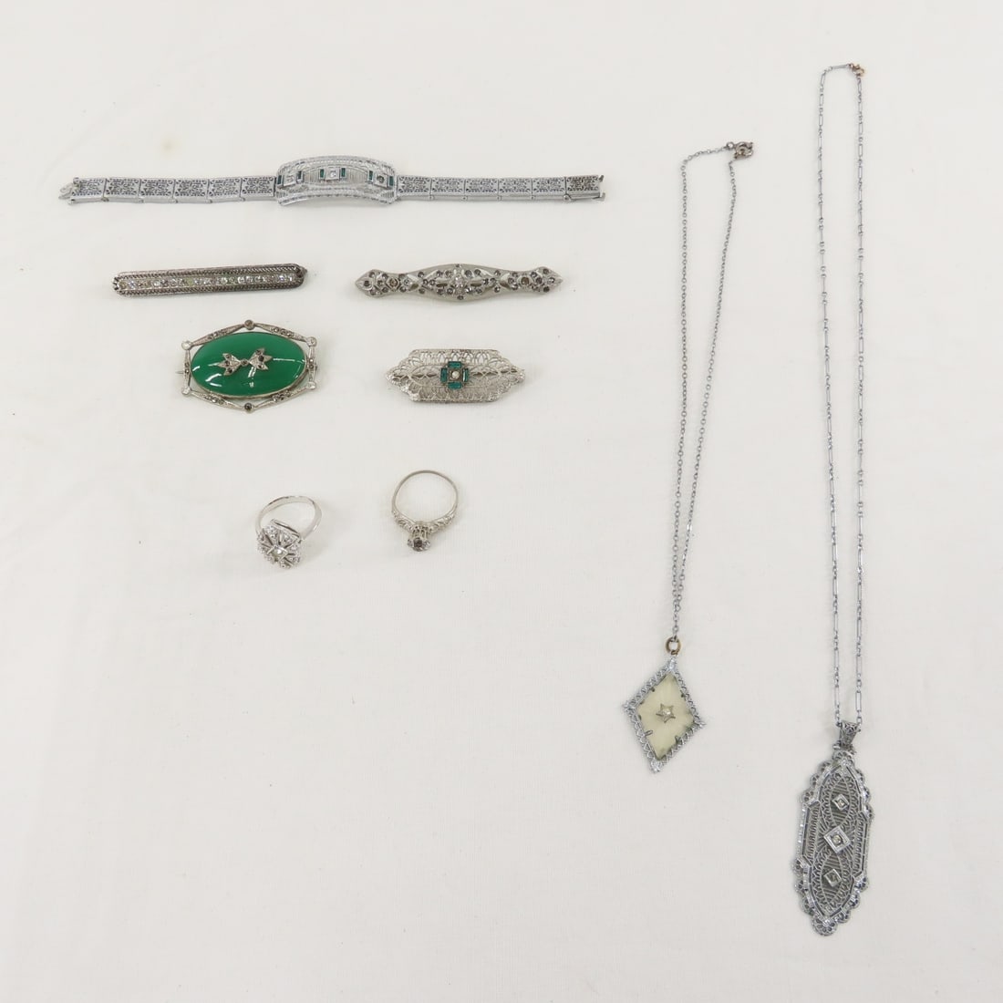 Vintage Filigree Jewelry with Sterling Brooch: Vintage Filigree Jewelry with Sterling Brooch - 1 sterling bar brooch with rhinestones, bracelet marked SC, size 6 1/2 ring by Avon, size 8 NEMCO ring, necklaces and more. LOT SIZE: 6x4x2" 1 LB All in