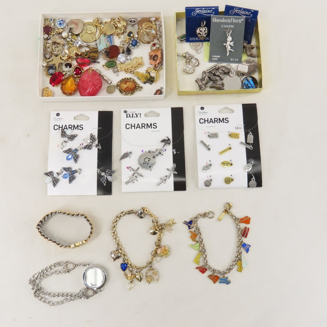 Vintage Charm Bracelets, Charms, Pendants & More: Vintage Charm Bracelets, Charms, Pendants & More - some sterling 56 grams/1.9 ounces. LOT SIZE: 6x6x6" 1 LB All information and photos, which are part of the description, are intended to be as accurat