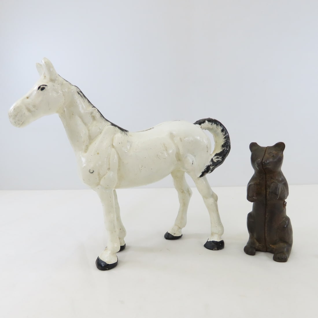 Antique Cast Iron Horse and Bear Banks: Antique Cast Iron Horse and Bear Banks - unmarked, horse is 10" tall. LOT SIZE: 10x11x4" 8 LBS All information and photos, which are part of the description, are intended to be as accurate as