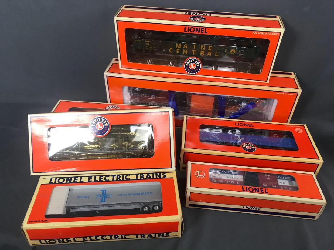 7 Lionel Freight car O scale train lot: 7 Lionel Freight car O scale train lot. Included are Union Pacific heritage boxcar 6-27254, 2 West side lumber item 6-17567, Boston and Maine flatcar with trailer 6-16911, Bangor and Aroostook boxcar 