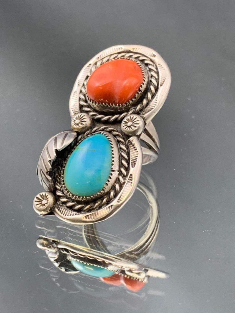 Sterling silver turquoise and coral ring with fine: Sterling silver turquoise and coral ring with fine stamped overlay hallmarked Herbert Pino. Size 5 front setting 1.75 x .8 in.