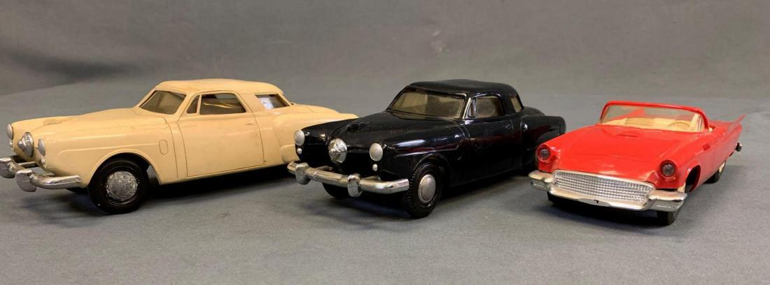 Three vintage toy cars, two Studabakers, and (1 of 8)
