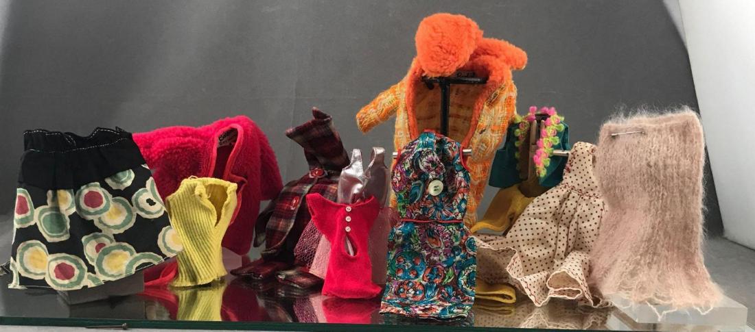 Lot of vintage doll clothes some Barbie from 50s-60s: Lot of vintage doll clothes some Barbie from 50s-60s. Lot includes a red plus an orange coat, 3 dresses, pink skirt, bathing suit, flannel shirt with pants plus a blue top with yellow pants set, an ap