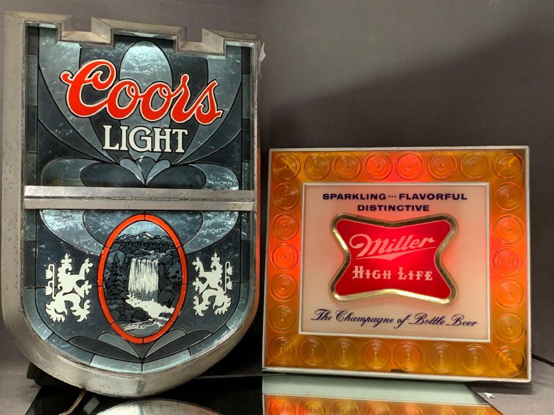 Lot of Two Light Up Bar Signs, Coors and Miller: Two vintage light up bar signs in good , working condition. The Coors Light vintage faux stained glass wall sign, made by KCS industries Inc.Sign measures approximately 18 1/2 x 12 1/2 x 4". Miller Hi
