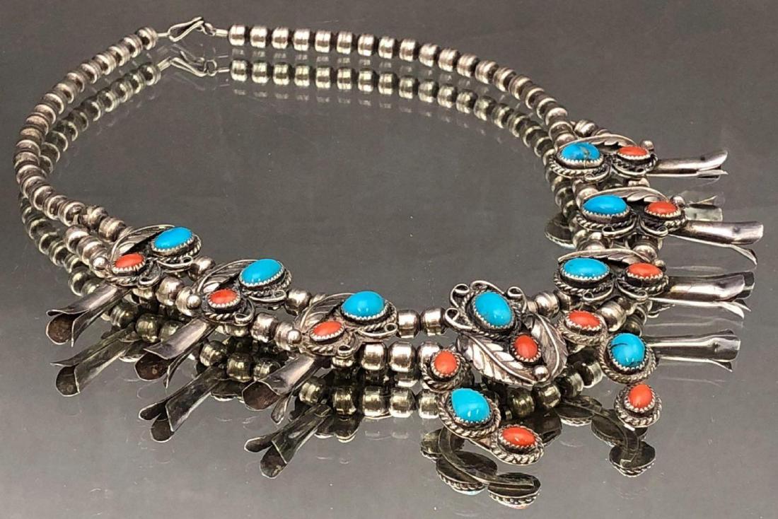 Native American Turquoise and Coral Sterling Squash: Native American sterling silver turquoise and coral squash blossom necklace with leaf overlay and 8 stone naja 64.7g. Approximately 17 in, central naja 2 x 1.8 in.All credit cards will be manually ver