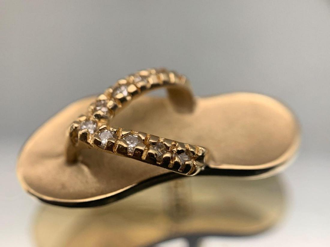 14k Gold & Diamond Sandal Charm: 14k gold and 9 diamond sandal charm, 1.8g hallmarked. Approximately .75 x .15 in. CREDIT CARDS WILL BE MANUALLY VERIFIED PRIOR TO SHIPMENT
