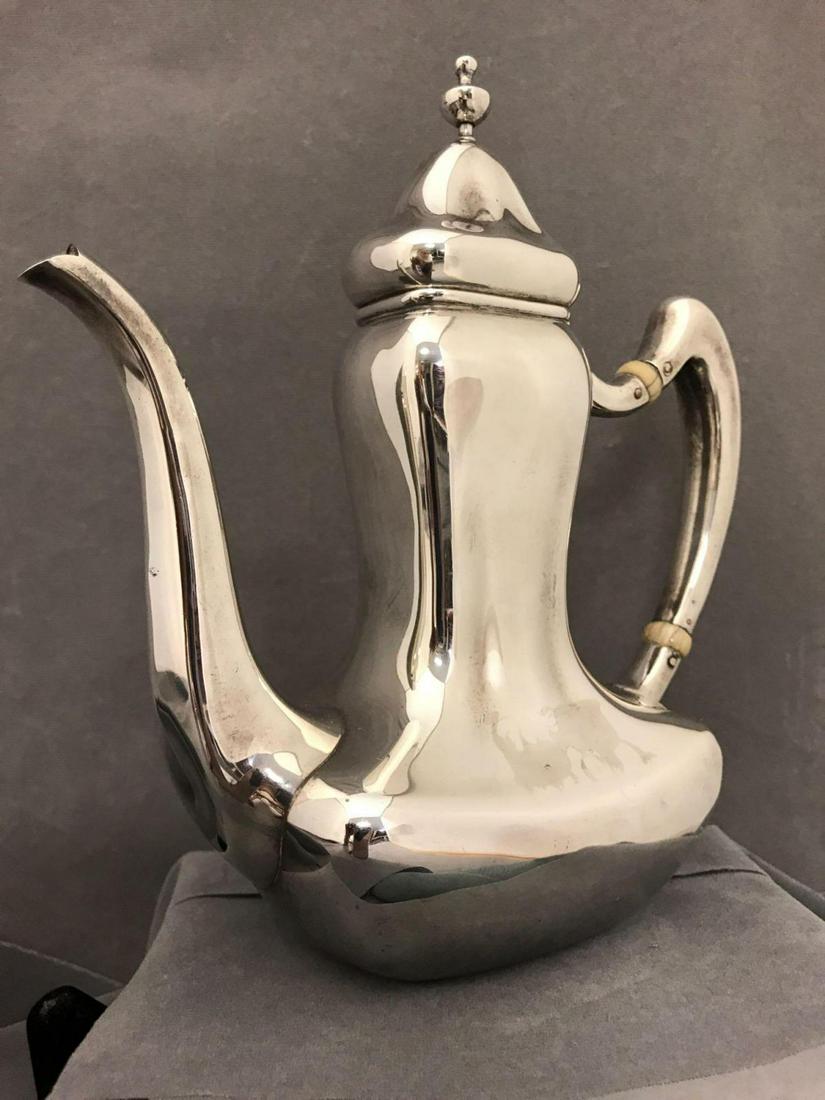 Sterling silver teapot, Proceeds go to Friends of: Sterling silver teapot. Marked sterling 617 (see pictures for maker stamp and other etchings). Measures approximately 7 inches from spout to handle, 7 1/2in tall X 3in wide. Proceeds go to Friends o