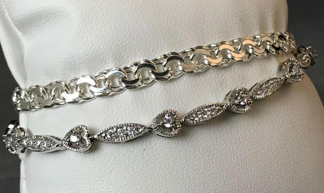 Two sterling silver bracelets: Two sterling silver bracelets. Flat link bracelet marked Italy. Heart link CZ tennis bracelet marked SLC 8in.