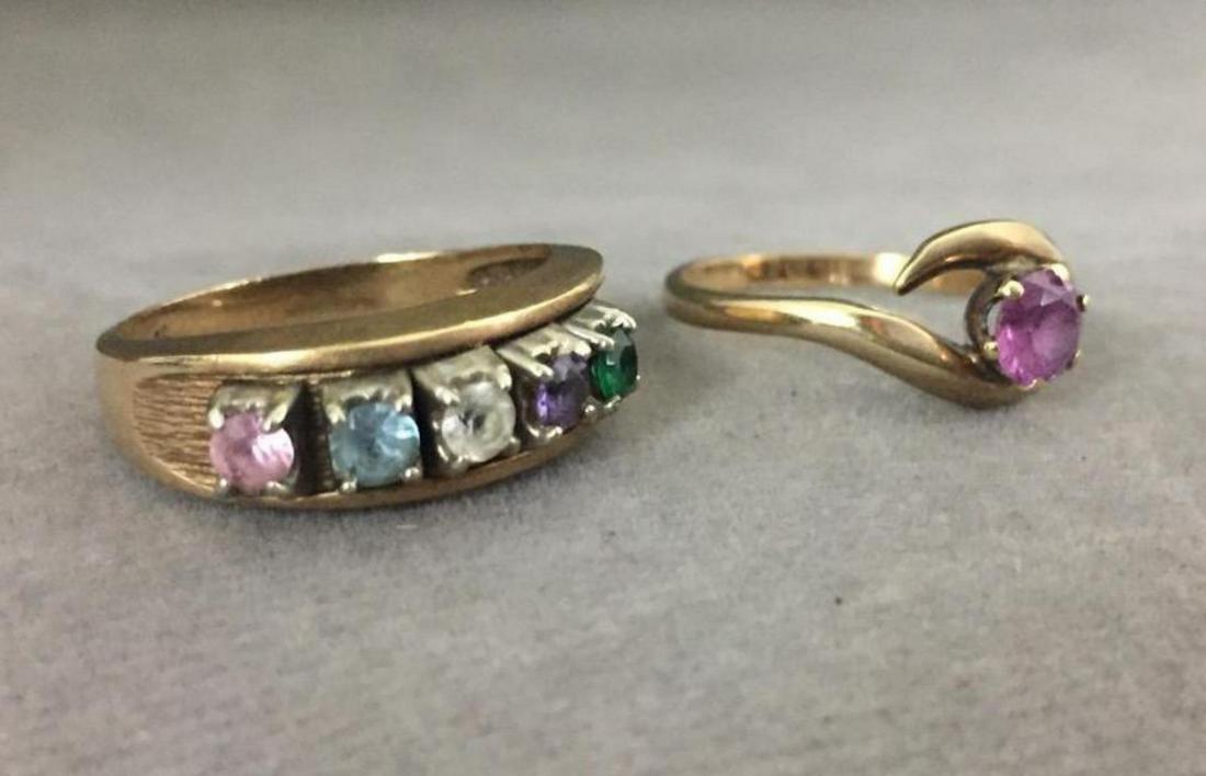 (2) 10 karat gold gemstone rings: (2) 10 karat gold gemstone rings. One is a solitaire with a pink stone. The other has 5 colored stones. Total weight of both rings is 6.8 grams. SZ 6.75 and 7.50 All credit cards will be manually veri