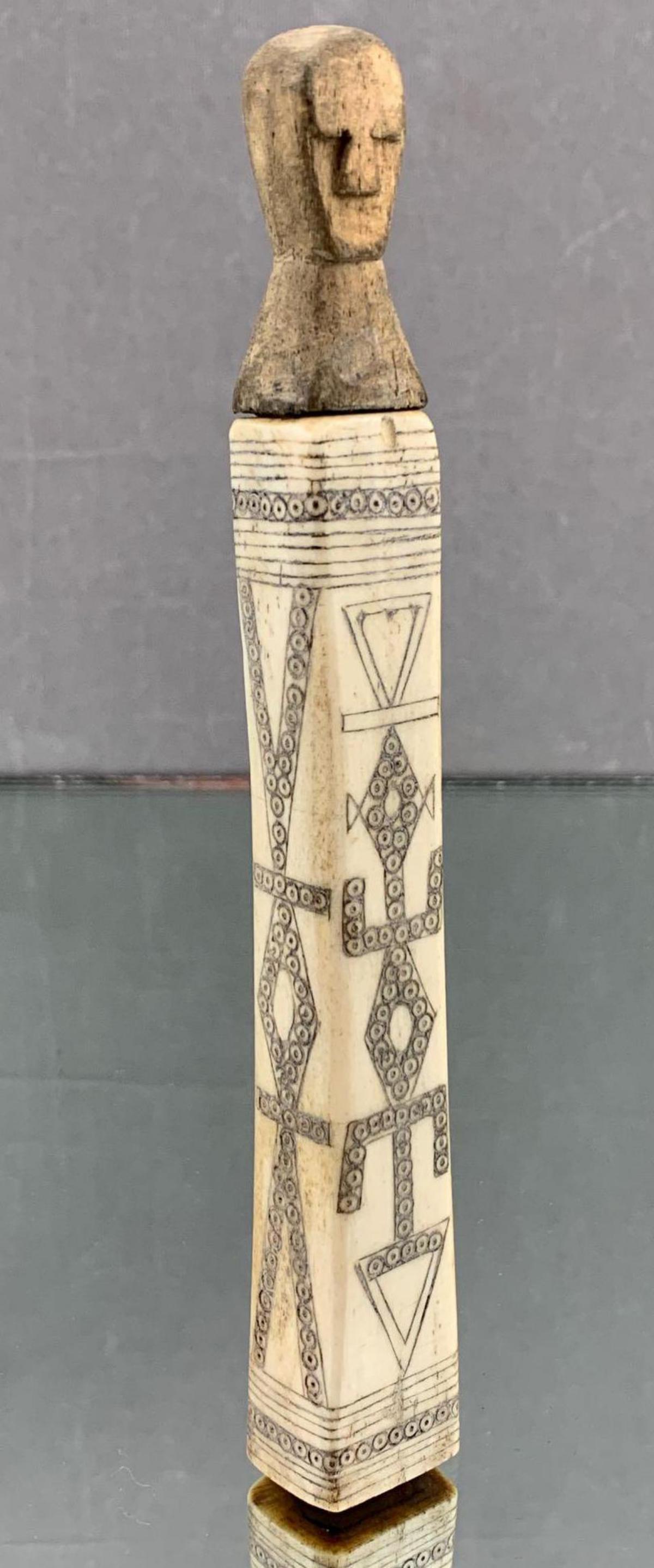 African Hand Carved Ox Bone Vial With Figural Stopper: Older African hand carved ox bone container with figural carved stopper. Approximately 6.6 x .75 x .6 in.