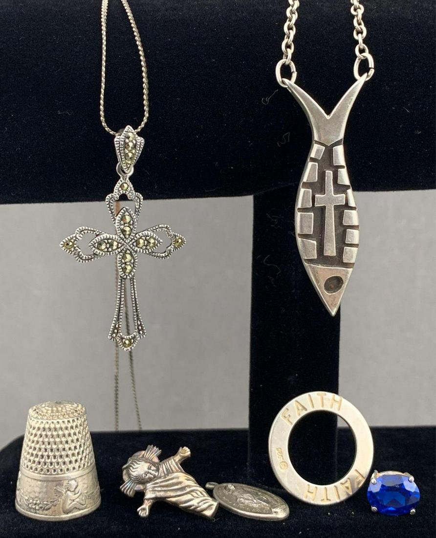 Sterling Silver Miscellaneous Lot: Sterling silver religious jewelry and thimble lot of 7, 32.1g., necklaces measure approximately 20 and 15.5 in., thimble approximately .65 x .75 in. Includes 2 necklaces, one earring with blue stone, 