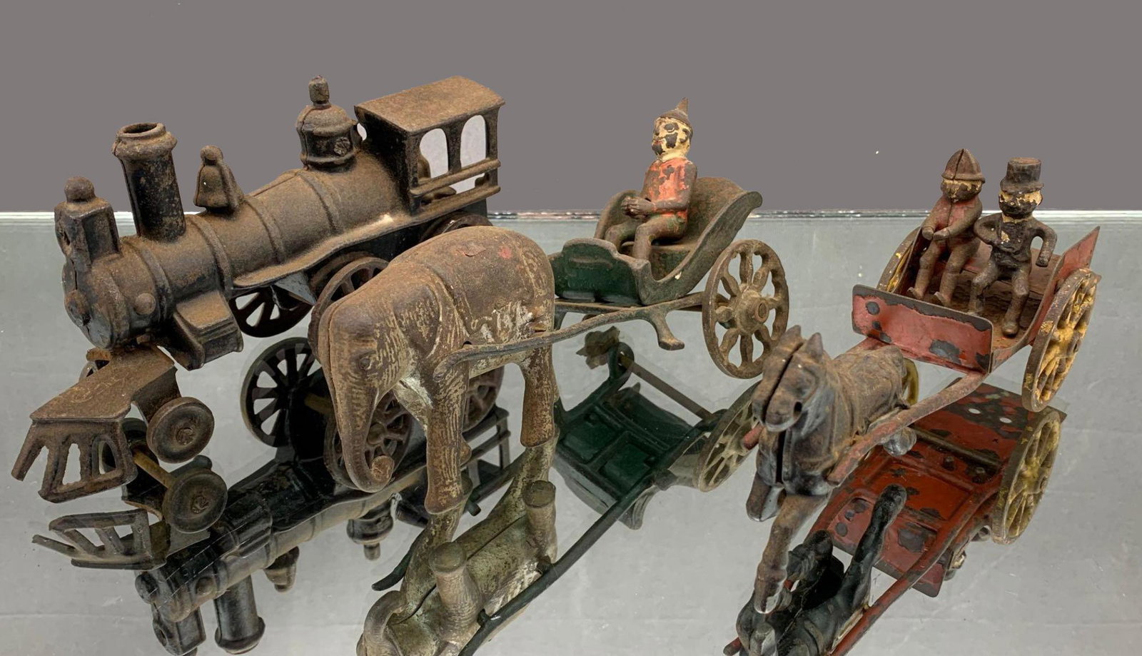 3 Antique Cast Iron Toys: 3 Antique Cast Iron Toys, includes horse-pulled carriage, elephant pulled carriage, and train engine. Great for parts. heights approximately 3.0-3.75 inches, widths approximately 2.0-3.0 inches, lengt