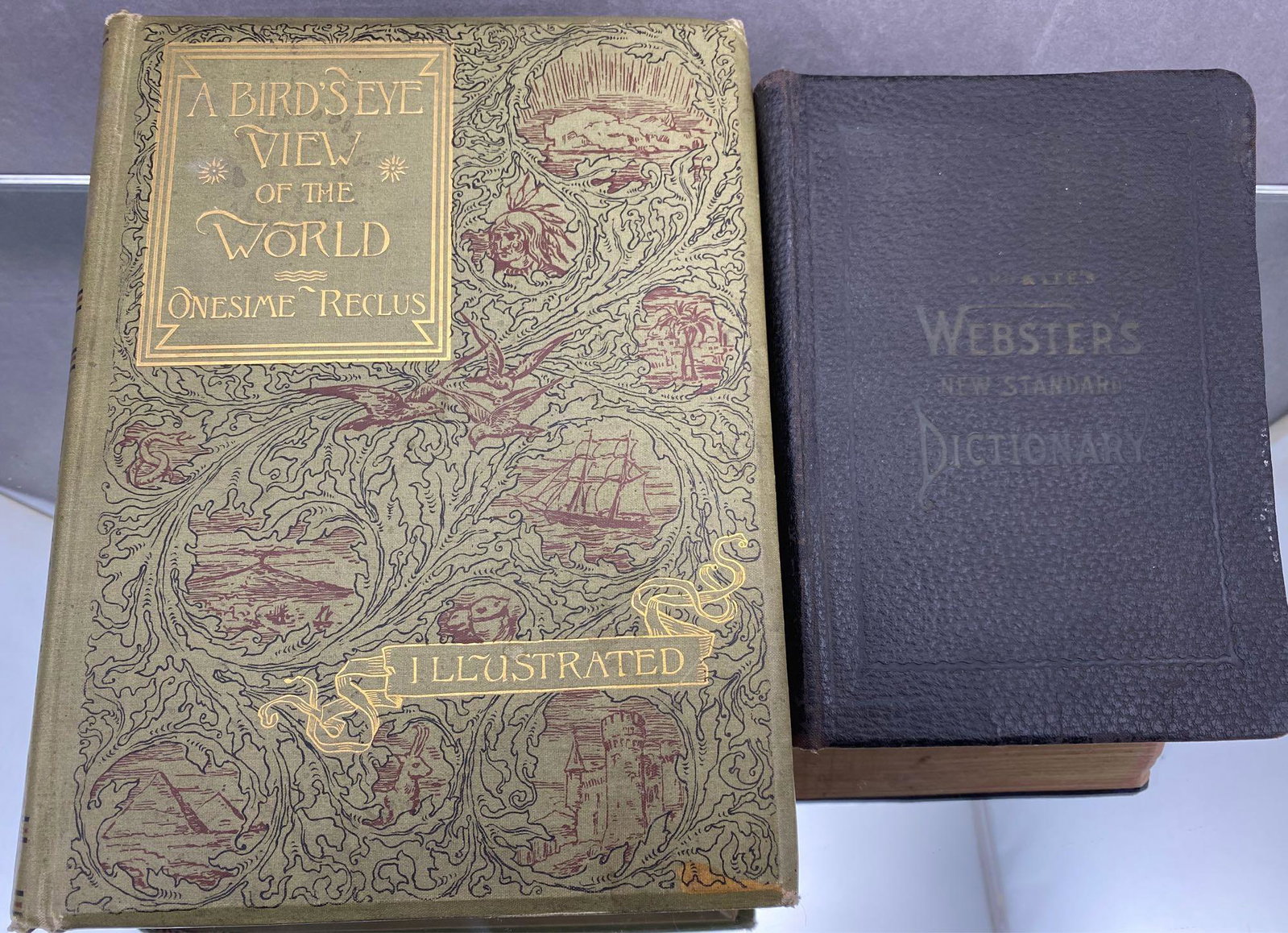 2 Antique Books, A birds Eye View of the World &: 2 Books, A Birds Eye View Of The World By Onesime Reclus and Laird And Lees Websters New Standard Dictionary, published in 1887 and 1908.
