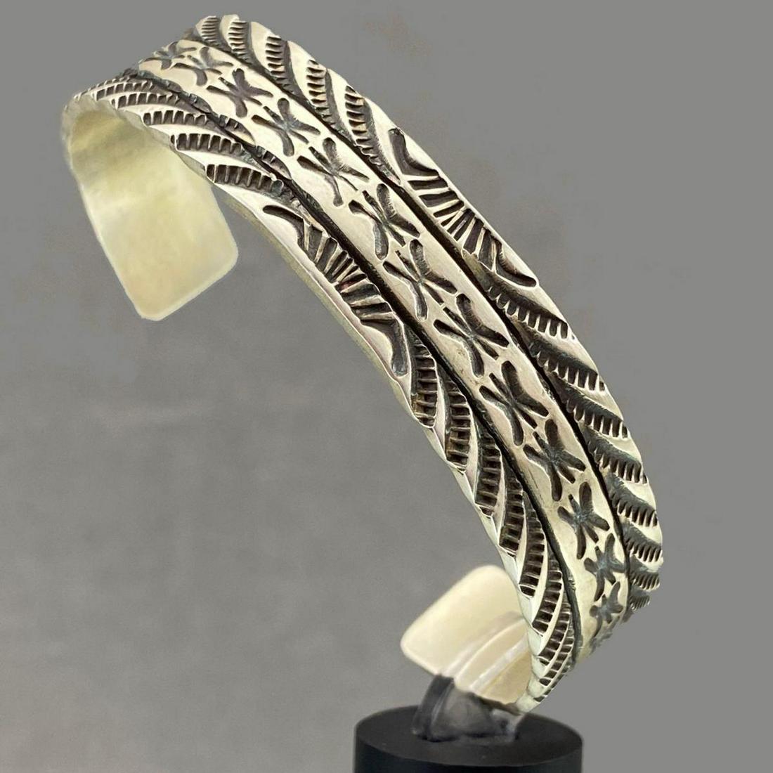 Navajo Sterling Silver Cuff With Detailed Stampwork,: Navajo Sterling Silver Cuff With Detailed Stampwork, 27g, by Silversmith Rick Enrico, signed RE Sterling. Approximately 5.5 in. inside and 1.5 in. at cuff break.