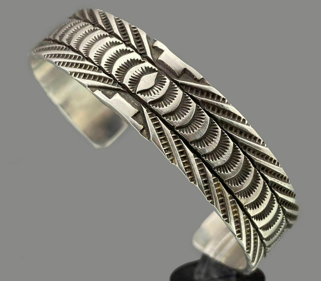 Navajo Sterling Silver Cuff With Duplicate Sided Stamp: Navajo Sterling Silver Cuff With Duplicate Sided Stamp Work, 27.1g. By Silver Smith Rick Enrico. Cuff break 1.8125, Inside measurement 5.50, Width .50in. All measurements are approximate.Â