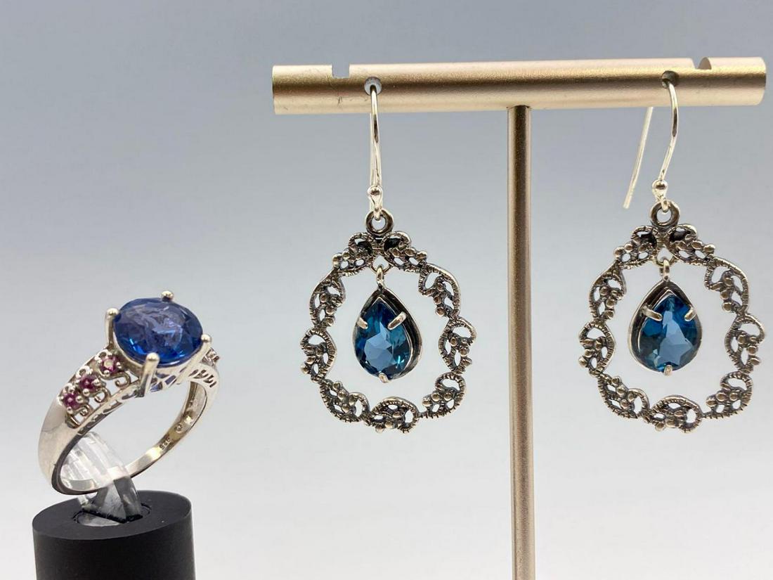 3 Piece Sterling Silver and Blue Topaz & Spinel Lot: 3 Piece Sterling Silver and Blue Stone Pair of Earrings and Ring, Ring test as Spinel, Earring Tests as Topaz. 925 marked ring weighs 4.4g, total weight 11.7g, ring marked 925, earrings marked "Israel